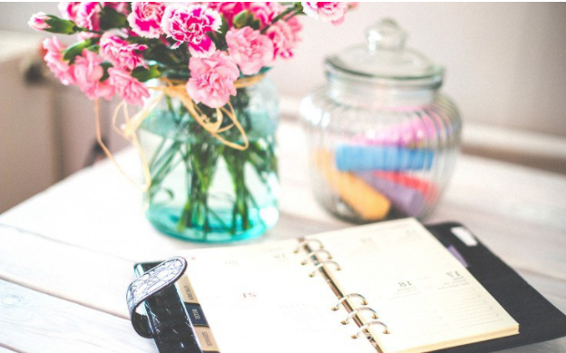 flowers and planner on desk